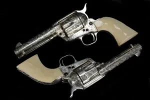 Colt Single Action Army Class D engraved pair with silver-plated finish and ivory grips image 1
